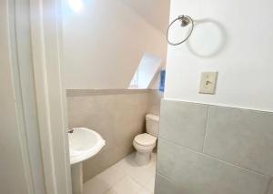 a white bathroom with a toilet and a sink at Superb 1BR Apartment in NYC! in New York