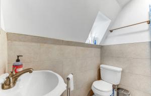 a bathroom with a toilet and a sink and a bath tub at Superb 1BR Apartment in NYC! in New York