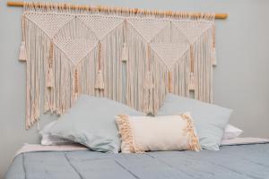 a bed with a headboard with a pillow on it at Quintinha Tropical - Panoramic Gateway to Madeira in Funchal +54 photos