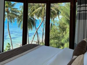 Ce lit se trouve dans un dortoir offrant une vue sur l'océan. dans l'établissement Heron Beach Hotel - The Best Maldivian Getaway in Dhiffushi,Maldives, à Dhiffushi