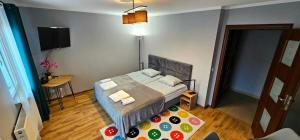 a small bedroom with a bed and a table at Miami Vice apartament by Karl in Radom