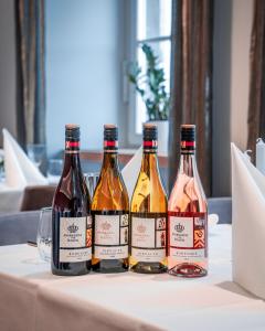 three bottles of wine sitting on a table at Hotel am Markt in Wipperfürth