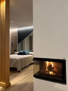 a living room with a fireplace and a bedroom at Loft luxury Mirador in Cádiz