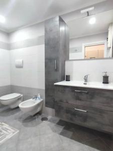a bathroom with a sink and a toilet and a mirror at Vista sull'Eremo in Naples +16 photos