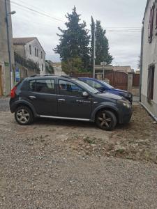a black car parked on the side of a street at Maison de village in Ventenac-Cabardès