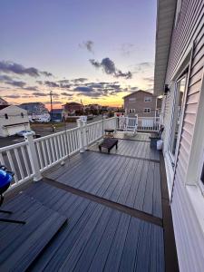 a wooden deck with a bench on a house at Cozy East Haven Apartment - Walk to Beach! in East Haven