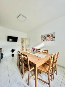 a dining room with a wooden table and chairs at City Wohnung Zentral 85-5 in Dortmund