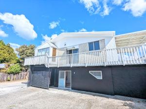 a house with a balcony on top of it at 4 Bedrooms Escape, close to CBD in Rotorua