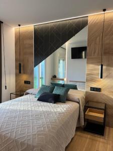 a bedroom with a large bed with a large headboard at Loft luxury Mirador in Cádiz