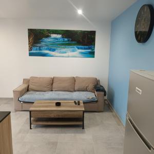 a living room with a couch and a coffee table at Nouveau Loft T2, connecté internet fibre et wifi in Saint-Quentin