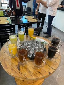 a wooden table with glasses of drinks on it at Ribeirao Hotel in Sousa