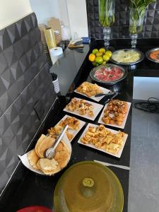 a buffet with many different types of food on a counter at Ribeirao Hotel in Sousa