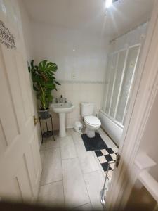 a bathroom with a toilet and a sink at Double size and Single room in Barking in Barking
