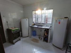 a kitchen with two refrigerators and a sink in it at Casa de Praia em Pirangi in Nísia Floresta