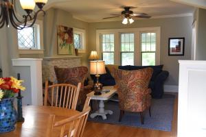 a living room with a table and chairs and a couch at Cozy Home in Milwaukee Near Festivals and Brewers in Milwaukee