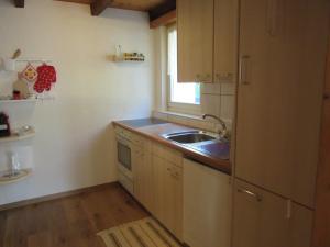 a small kitchen with a sink and a window at Maisonette in Biasca