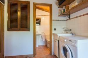 a kitchen with a washing machine in a bathroom at CASA RÚSTICA EN MAS ENFABONA in Els Ibarsos