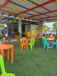 a group of tables and chairs under a roof at Baru sunset in Baru