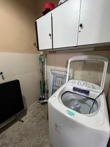 a washing machine in a room with a cabinet at STUDIO 203 | WIFI 600MB | RESIDENCIAL JC, um lugar para ficar. in Belém