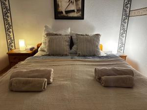 a large bed with two pillows on top of it at Hotel Royal in Betzdorf