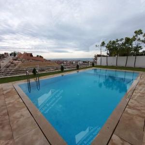 - une grande piscine bleue au-dessus d'un bâtiment dans l'établissement Nostalgic Nirvana Villa Taghazout Bay ocean & mountain view, à Taghazout