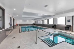a large swimming pool in a building at Sandman Hotel Grande Prairie in Grande Prairie
