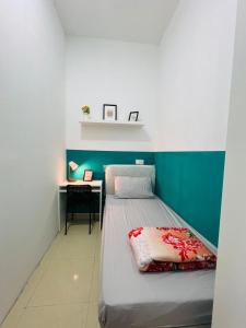 a bedroom with a bed and a desk in it at Short Stay Partition Room in Al Barsha 1 Near Mashreq Metro in Dubai