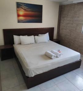 1 dormitorio con 1 cama grande y toallas. en HOTEL SAN THOMAS INN, en Panamá