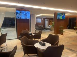 a lobby with chairs and tables in a building at جوهرة البحر للشقق المخدومة in Jazan