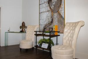 two chairs and a table in a living room at Serenity in the Marigny in New Orleans