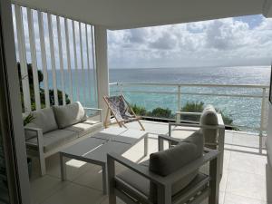 a living room with a view of the ocean at Face à la mer in Le Gosier