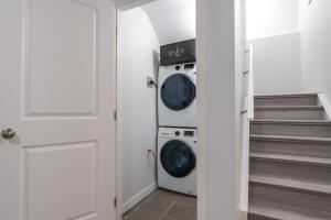 a laundry room with a washer and dryer at Serene Elegance 2BR Gem with modern conforts in Calgary