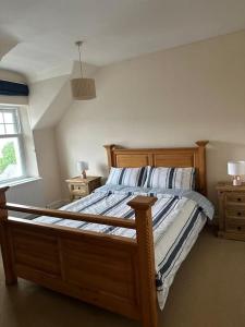 a bedroom with a wooden bed with two night stands at 4 Caberfeidh in Fort William