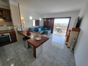 a kitchen and living room with a couch and a table at Victoria Court II in Los Cristianos
