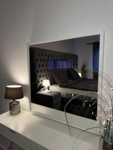 a reflection of a bedroom with a bed in a mirror at Apartment Laurier in Alsdorf