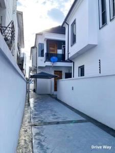 a alley way with a building and a umbrella at IVYs 4 Bedroom Luxury Entire Apartment Duplex with Wifi in Lekki in Ibeju