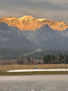 a windmill in a field with mountains in the background at Mountain Magic in Golden