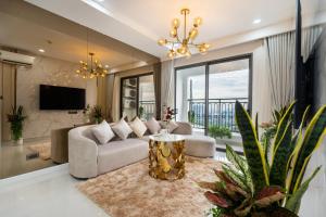 a living room with a couch and a tv at 2Br-Top Fl-Amazing View-Hana Apt in Ho Chi Minh City