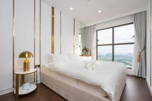 a white bedroom with a large bed and a large window at 2Br-Top Fl-Amazing View-Hana Apt in Ho Chi Minh City