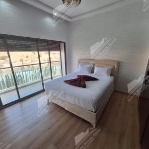 a bedroom with a bed and a large window at Blue Haven Villa 4 bedroomTaghazout Bay Amda in Taghazout