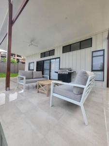 a patio with two chairs and a coffee table at Coastal Pod in Port Macquarie