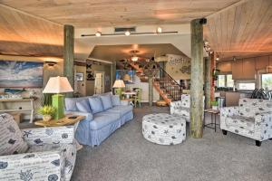 a living room with a blue couch and chairs at Chic Home: Ocean Views, Hot Tub & Game Room! in Flagler Beach +37 photos