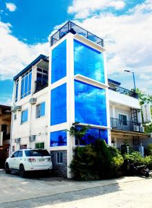 a building with large glass windows on the side of it at Vitasolo Hometel & Suite in Tagum