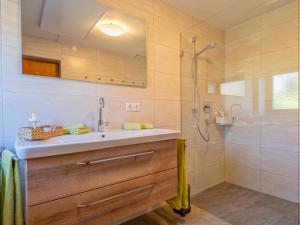 a bathroom with a sink and a shower at Landhaus Platzl in Hopfgarten im Brixental