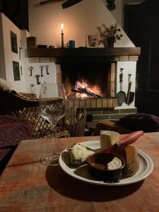 a plate of food on a table with a fireplace at Chalupa Šanov u Králík in Červená Voda