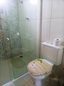 a bathroom with a toilet and a glass shower at Aconchego do velho chico in Piranhas
