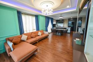 uma sala de estar com um sofá e uma cozinha em Santubong Suites Lower Level em Kuching
