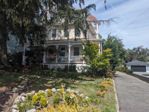 an old house with a flower garden in front of it at Sunny & Spacious Montclair NJ Apartment in Montclair