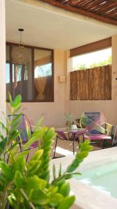 um pátio com cadeiras, uma mesa e uma piscina em Disfruta en La Casa de Lola / Enjoy at Lolas house em Progreso