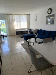 a living room with a blue couch and a table at Ocean Reserve in Sunny Isles Beach